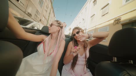 two women riding in a convertible