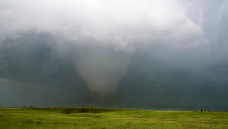 massive tornado approaching a green field