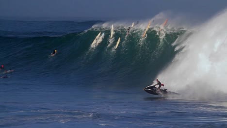 a jet skier braves huge waves in hawaii