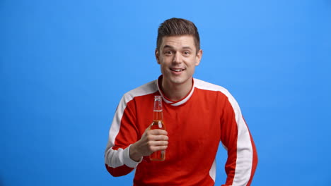 Studio-Shot-Of-Sports-Fan-With-Beer-Celebrating-Result