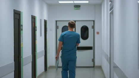 unknown doctor walking down hospital corridor. surgeon hurring to operation.