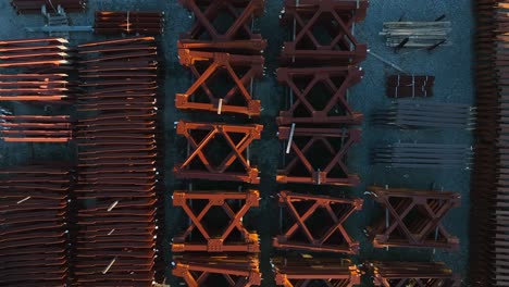 top down aerial of rusty steel products in outdoor yard