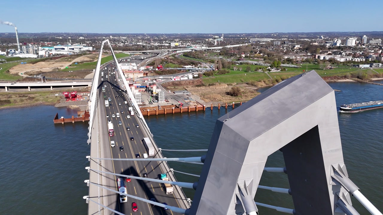 Drone frames tower with city and infrastructure behind