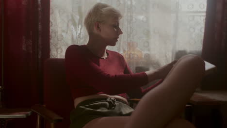 woman reading a book in a vintage chair