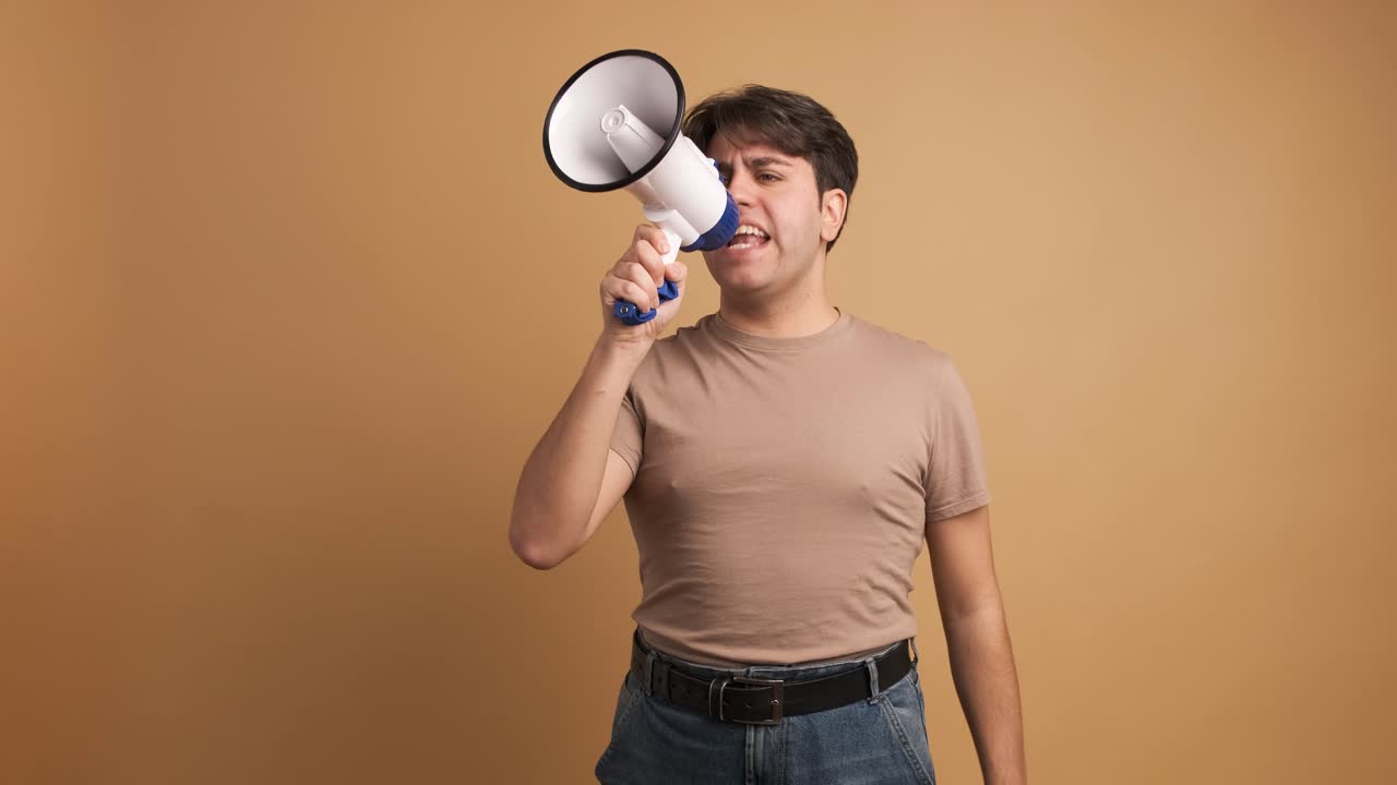 Young man screaming on megaphone during protest