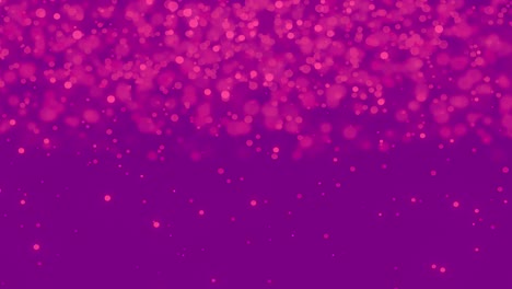 manchas rosadas brillantes que se mueven contra un fondo púrpura
