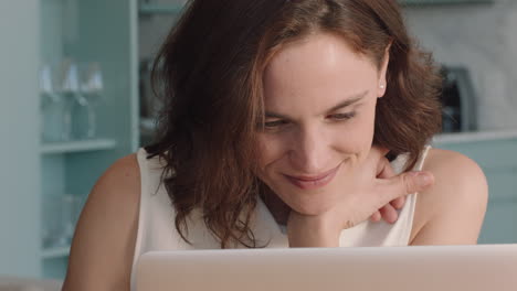 beautiful young woman using laptop working at home browsing online enjoying reading social media messages on computer typing email digital communication