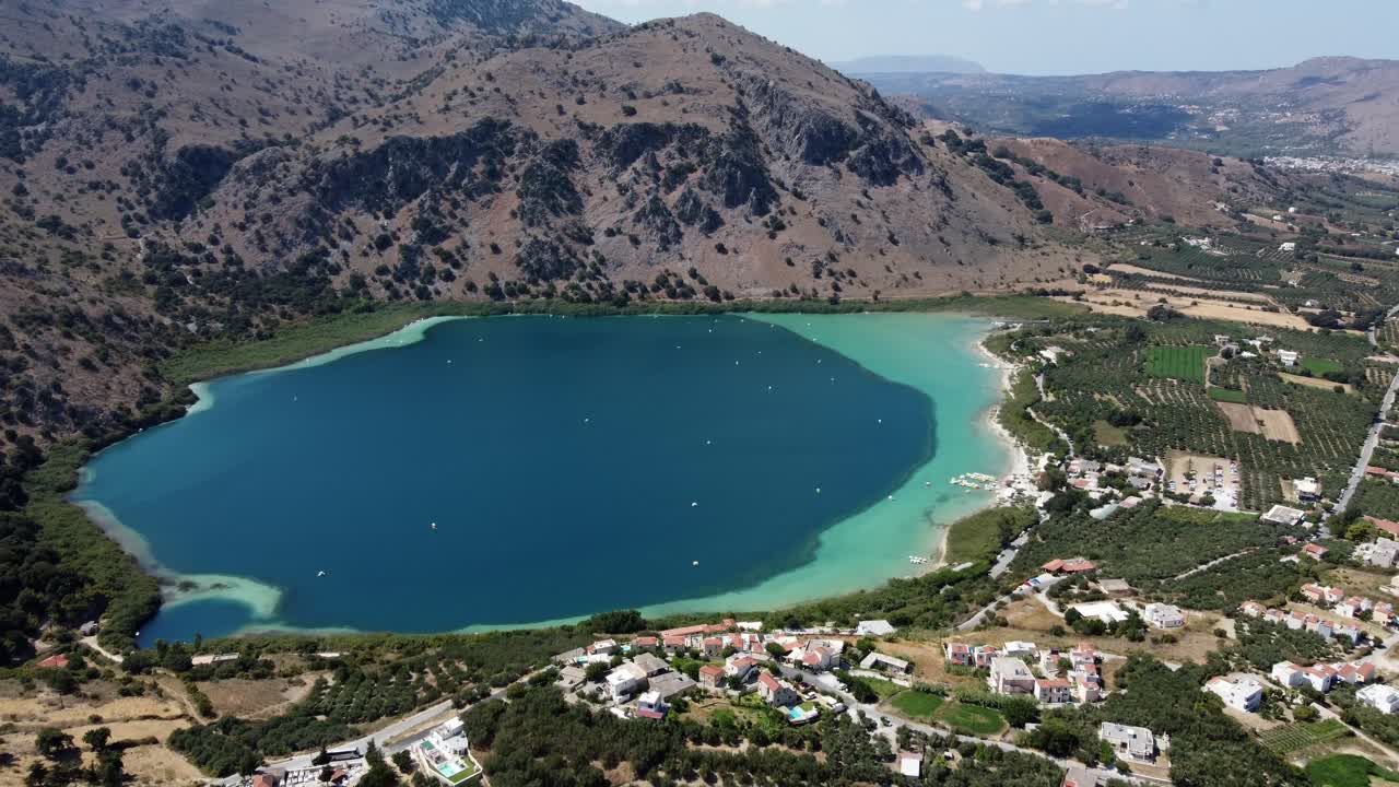 Kournas freshwater turquoise lake in Crete, Kournas mountainous village, Drone shot