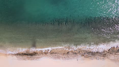 Overhead-drone-clp-of-waves-crushing-to-the-shore-in-Kavala,-Macedonia,-Greece