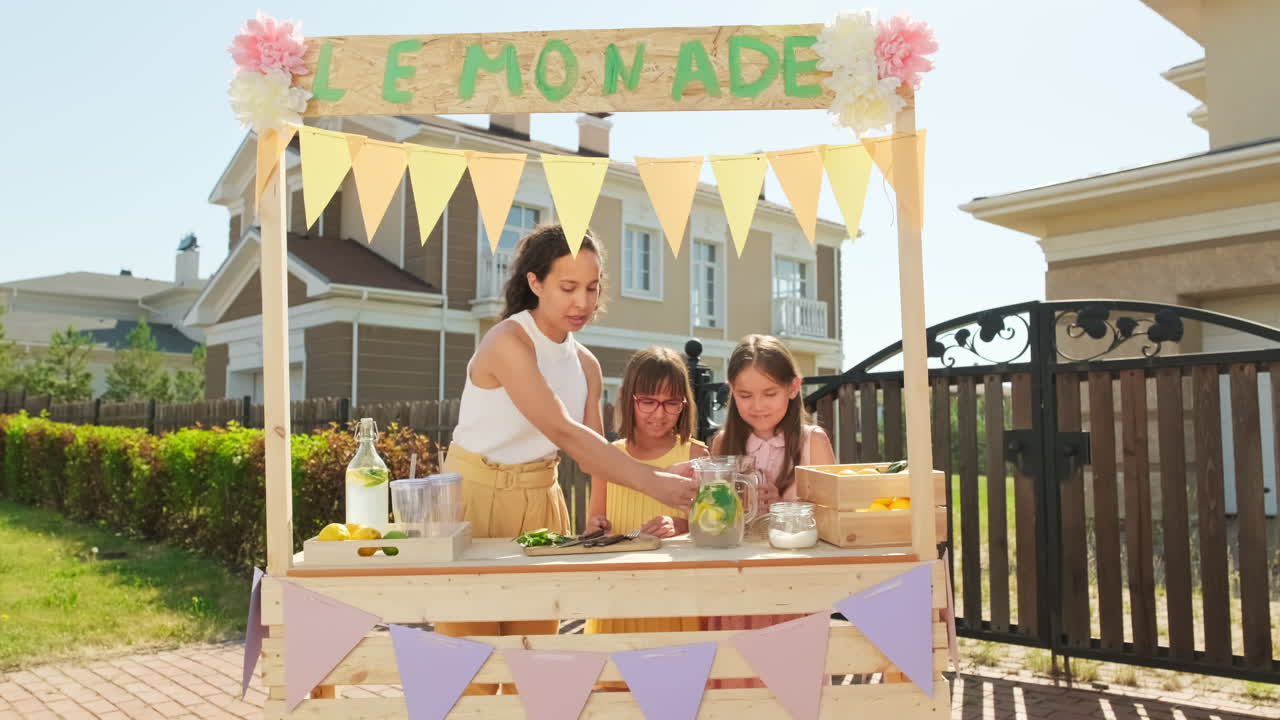 Woman With Two Little Girls At Lemonade Market