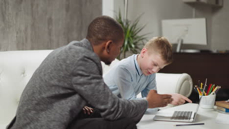 Little-boy-listens-to-African-American-English-teacher