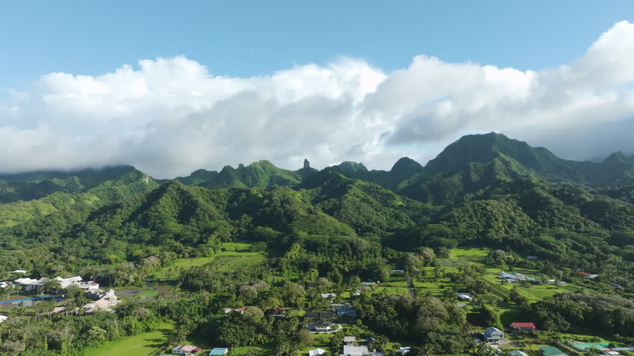 Tracking right aerial of The Needle mountain range in Rarotonga Cook Islands from Wigmore's area