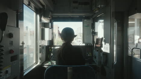 back view of a female conductor preparing the train cab before departure at the railway station in sendal, japan