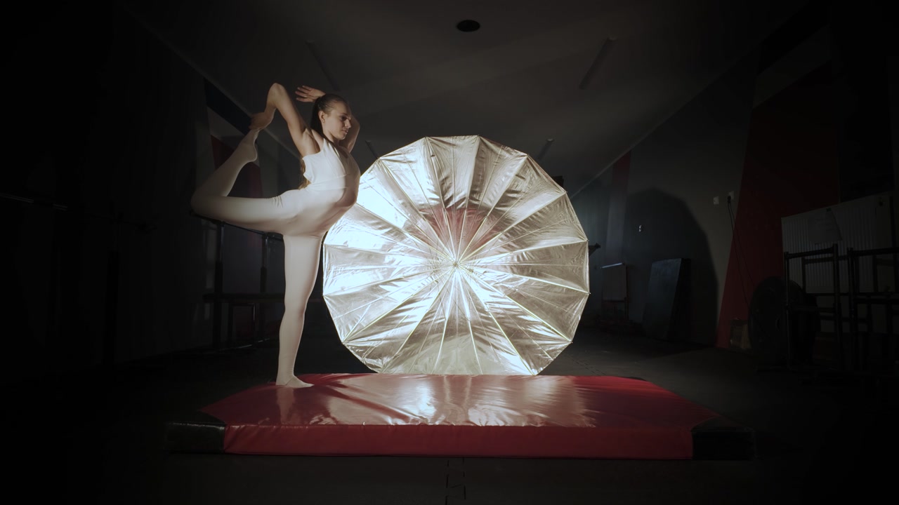 Girl gymnast failing doing a somersault on a mat. Slow motion