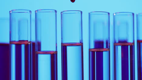 video of laboratory test tubes with copy space on blue background