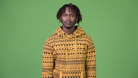 young handsome african man with finger on lips