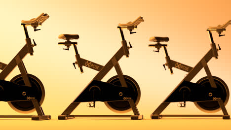 Row-Of-Training-Bicycles-On-orange-background.-Close-up-of-spinning-bikes-standing-in-a-row,-isolated-in-modern,-gym-or-fitness-club.-Seamlessly-looping-shot.-Health,-wellness,-cardio,-sport-concept.