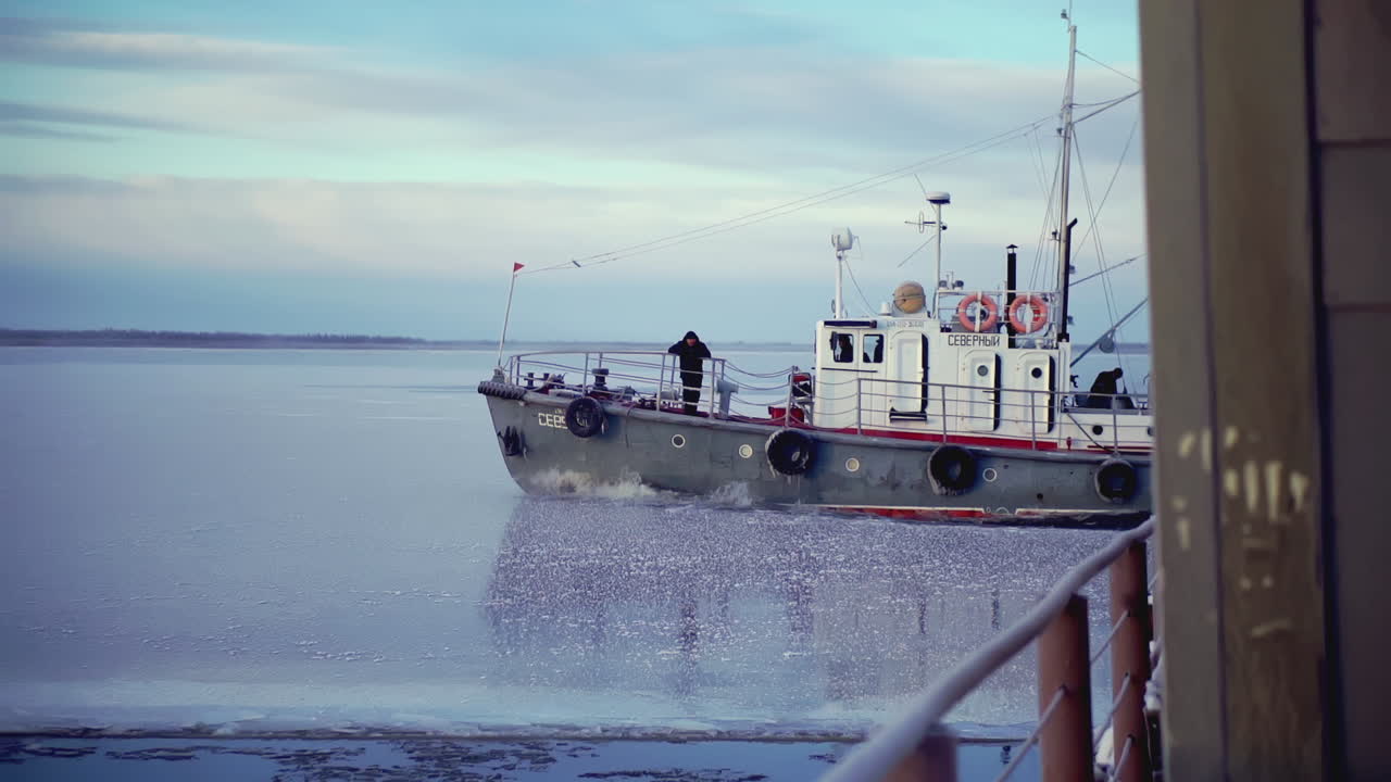 겨울 에 얼어붙은 강 을 항해 하는 견인선
