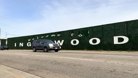 welcome to inglewood california road sign as cars pass on overcast day