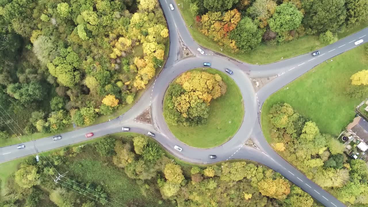 High angle aerial view over roundabout traffic driving rotation left
