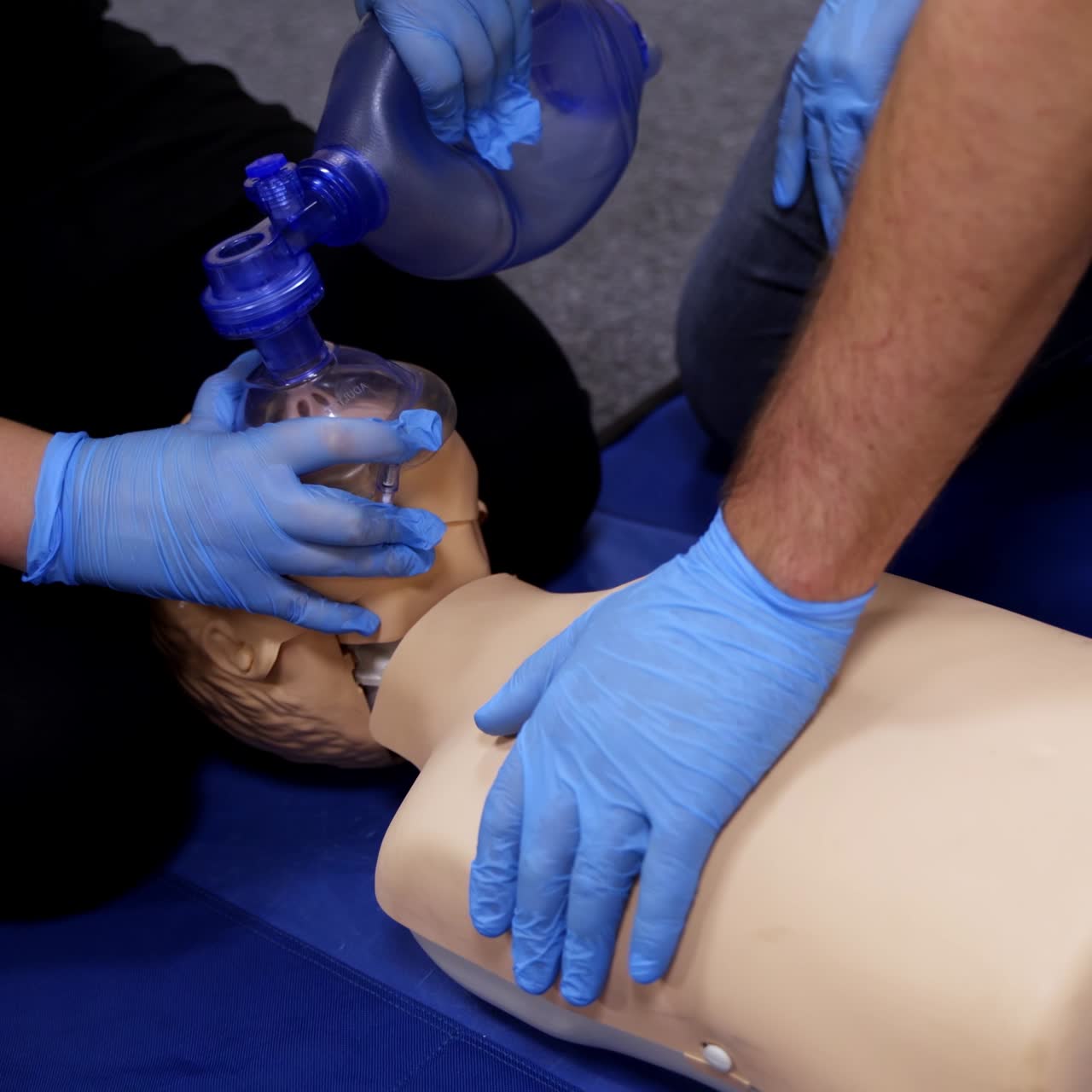 Chest compression on a dummy. Cardiopulmonary resuscitation. Training session on a chest compression and breathing by practitioners. Close-up