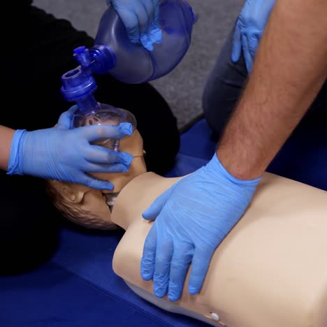 chest compression on a dummy. cardiopulmonary resuscitation. training session on a chest compression and breathing by practitioners. close-up
