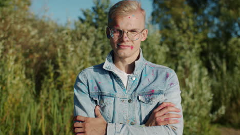 man covered in colorful powder at outdoor festival