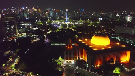 national monument and istiqlal mosque at night