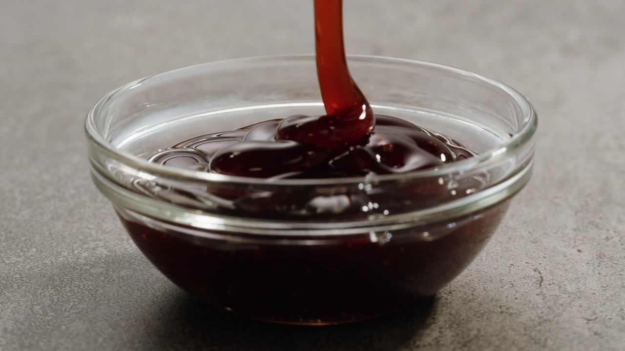 Pouring Brown Sauce into Glass Bowl