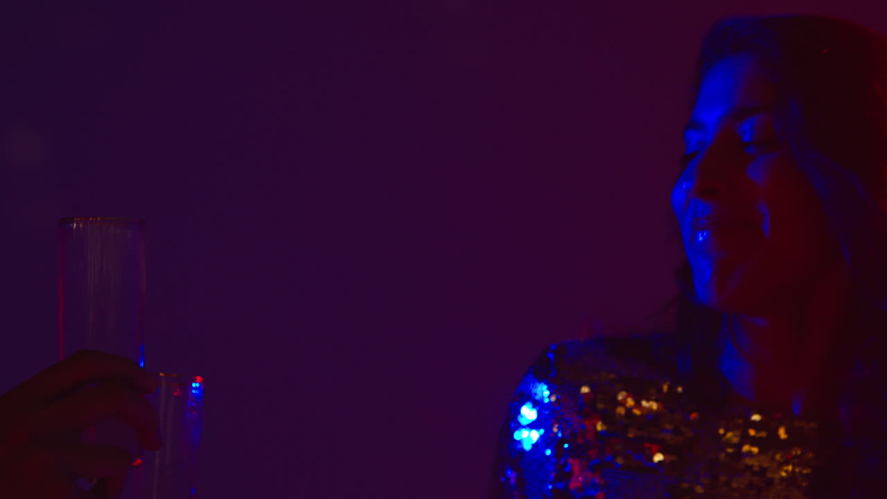 Close Up Of Two Women In Nightclub Bar Or Disco Dancing And Drinking Alcohol