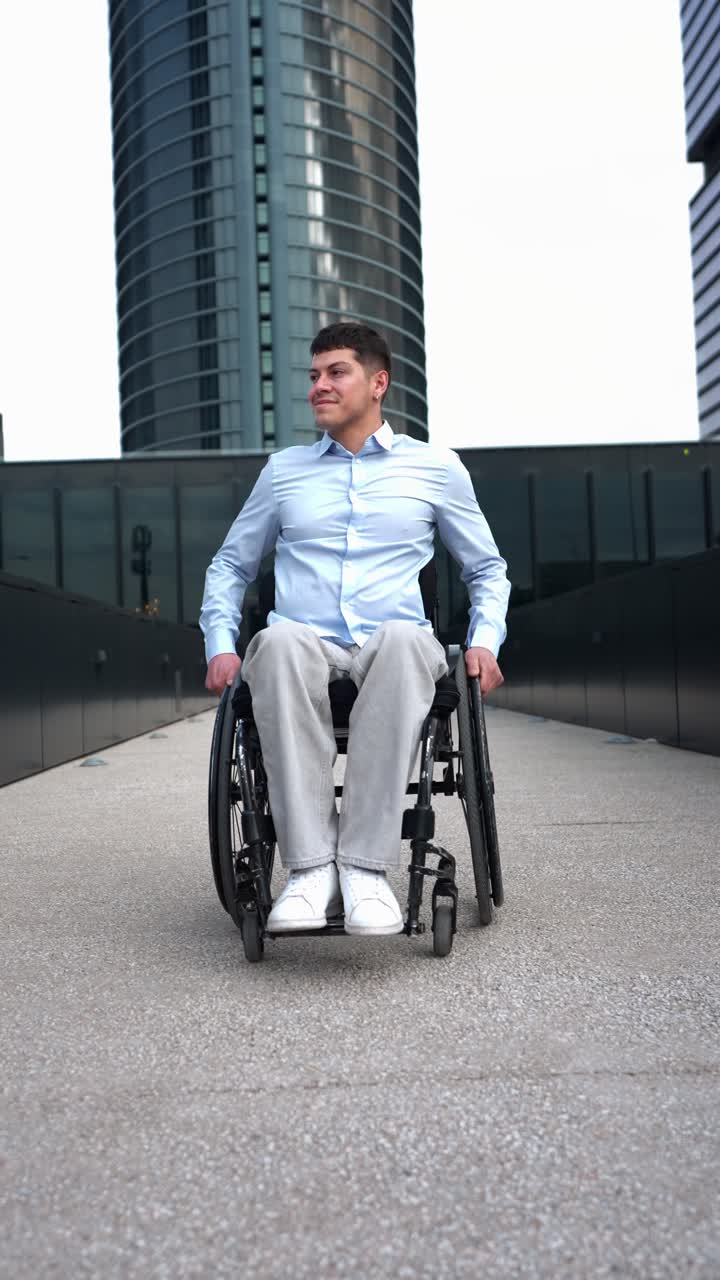 Smiling Young Man in Wheelchair in Modern City Environment