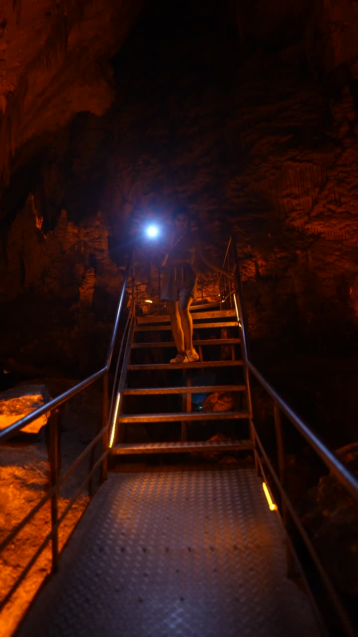 Person walking up stairs in a cave