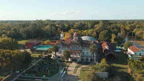 Aerial-Orbit-Of-Regatas-Las-Marinas-Exclusive-Rowing-Club-Near-De-La-Plata-River-Surrounded-By-Trees-At-Sunset,-Tigre-Buenos-Aires