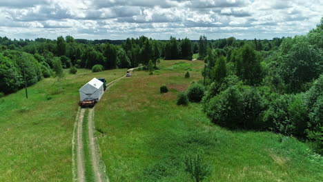 transporting a prefabricated cabin to a wilderness location - aerial view