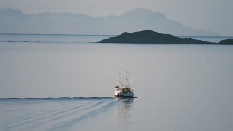 a small fishing ship leaving the fjord for the open sea