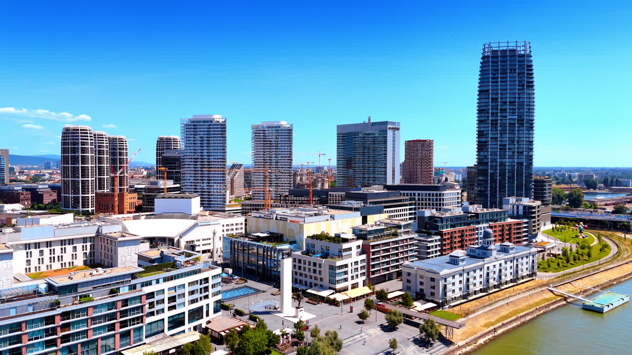 Diverse buildings at the waterfront of the Danube River. Aerial perspective on the quay of Bratislava, Slovakia.