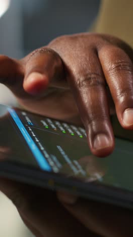 vertical video close up of programmer utilizing ai on tablet to optimize performance