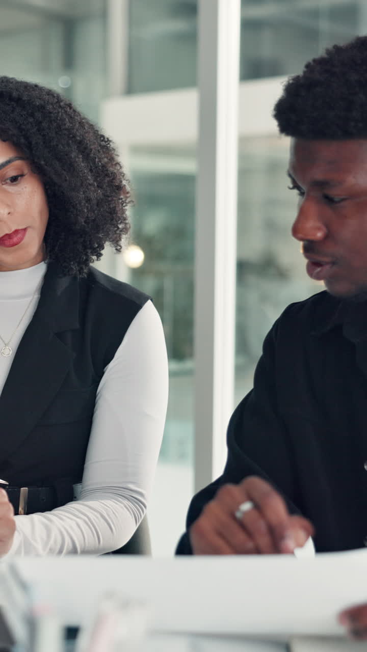 Young Business Professionals Discussing Documents in a Modern Office Meeting