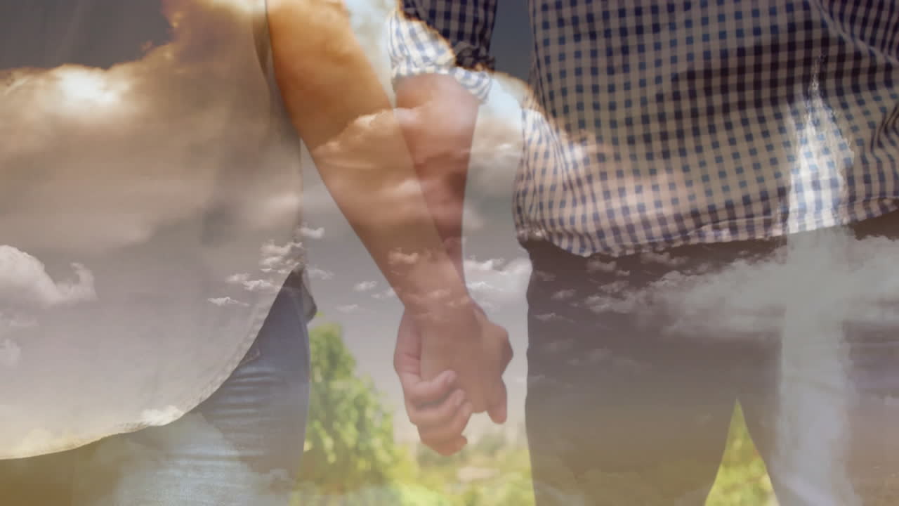 Holding hands, couple walking together under cloudy sky in scenic landscape