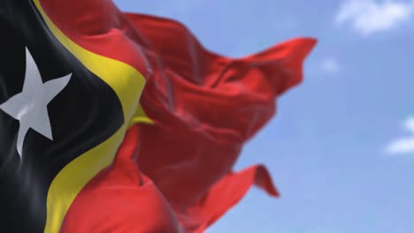 detail of the national flag of east timor waving in the wind on a clear day