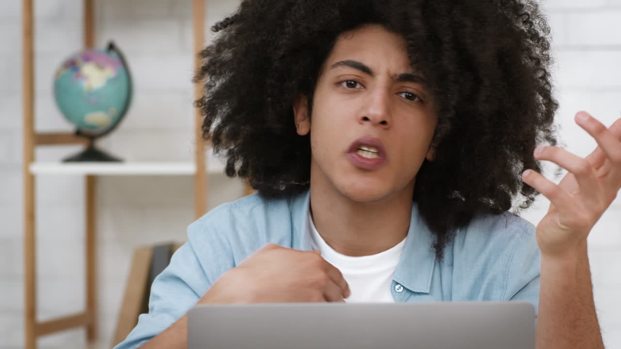 Young Man Frustrated with Laptop