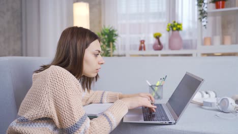 Young-college-student-girl-learning-and-learning-remotely-online-using-laptop.