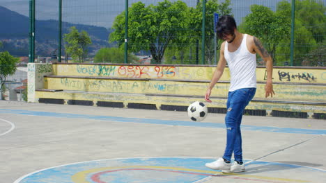 handsome man practicing soccer tricks