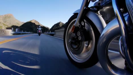 Two-motorcycle-riders-take-to-the-open-road-in-the-country-side