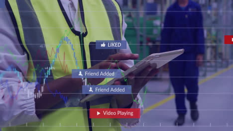 factory manager tapping tablet and phone in plant, displaying social alerts and financial charts
