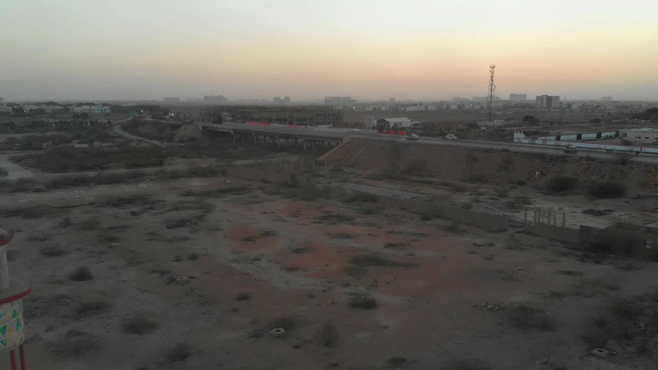Aerial View Of Mosque Minaret Near Highway In Karachi During Sunset. Dolly Back
