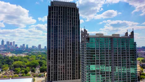 Aerial-drone-shot-slowly-rotating-around-skyscrapers-at-Atlantic-Station-with-downtown-Atlanta,-Georgia-in-the-background