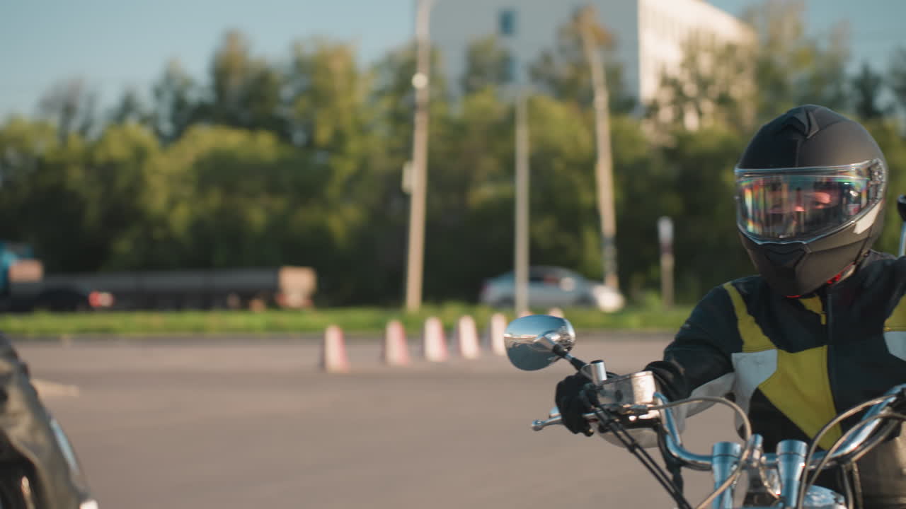 Lady holding helmet waits as rider on motorcycle approaches to pick her up, street with passing car and trees in background, creating dynamic urban transport