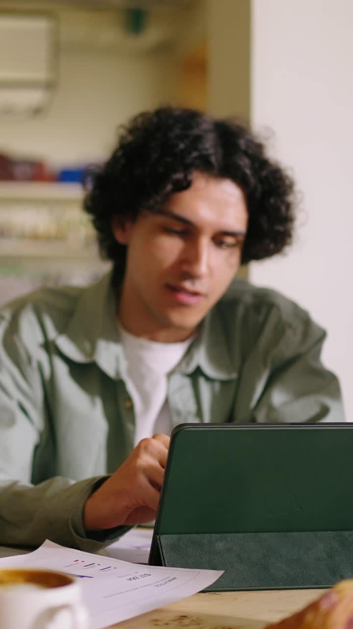 Young Man and Woman Discussing Work in a Cafe