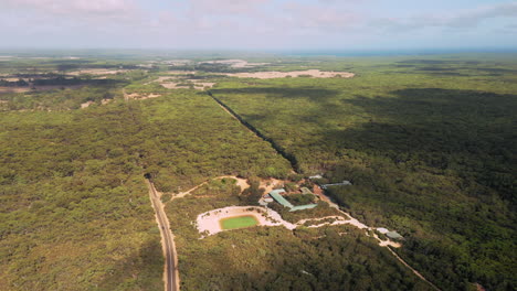 aerial view of a resort, with a pond, on kangaroo island, australia - pan, drone shot